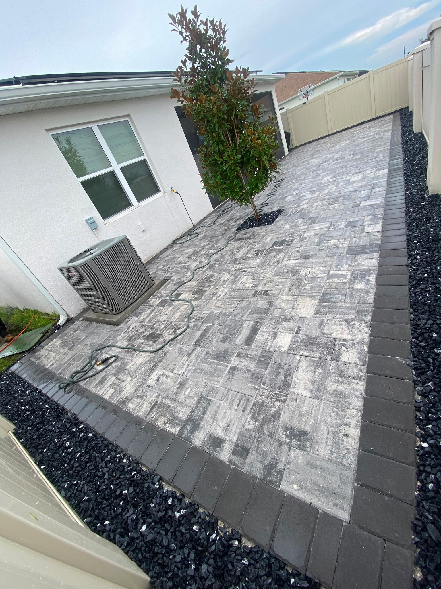 Paver driveway with black gravel border